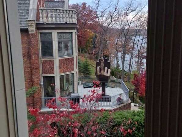 man-buys-home-next-to-ex-wife-and-erects-giant-middle-finger-statue