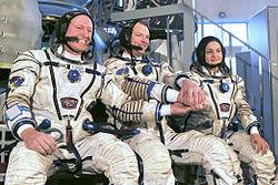 Expedition_39_backup_crew_members_in_front_of_the_Soyuz_TMA_spacecraft_mock-up_in_Star_City,_Russia